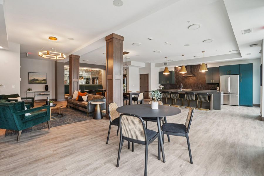 The Scenic modern open-concept living space with dining area, lounge, and kitchen featuring neutral tones and stylish decor.