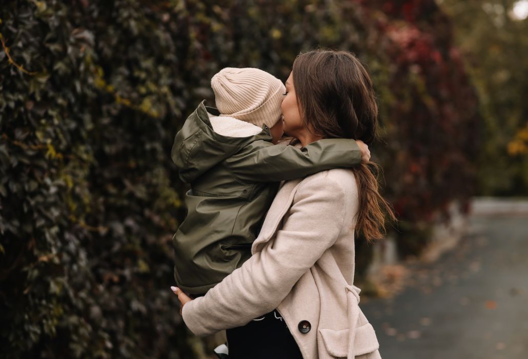 woman holding child in st paul neighborhood