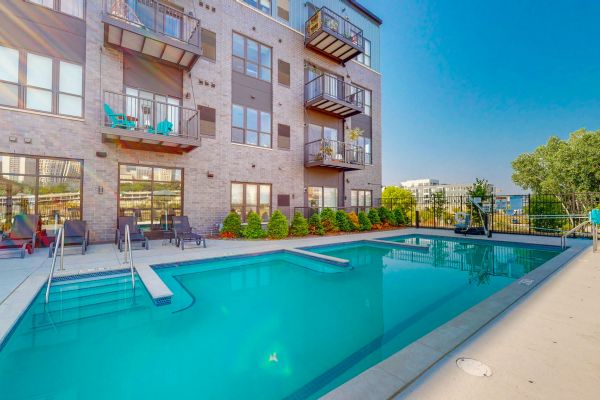 large pool with apartment backdrop